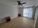 Bedroom with neutral tile floors, ceiling fan and natural light at 8765 Bardmoor Blvd # 107, Seminole, FL 33777