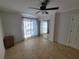 A well-lit bedroom featuring mirrored closet doors and neutral tile flooring at 8765 Bardmoor Blvd # 107, Seminole, FL 33777