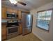 Modern kitchen with stainless steel appliances and light wood cabinets at 8765 Bardmoor Blvd # 107, Seminole, FL 33777