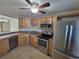 Modern kitchen with stainless steel appliances and light wood cabinets at 8765 Bardmoor Blvd # 107, Seminole, FL 33777