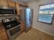 Kitchen featuring stainless steel appliances, wood cabinets, and window bringing in natural light at 8765 Bardmoor Blvd # 107, Seminole, FL 33777