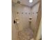 Walk-in shower showcasing updated tile and built-in shelving at 8765 Bardmoor Blvd # 107, Seminole, FL 33777