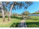 Expansive backyard featuring a stone pathway leading to an outdoor seating area at 9250 Rhea Dr, Odessa, FL 33556