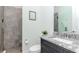 Bathroom features a gray stone shower, modern vanity, toilet, and framed art at 9250 Rhea Dr, Odessa, FL 33556