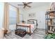 This cozy bedroom has a natural light from the window and a ceiling fan at 9250 Rhea Dr, Odessa, FL 33556