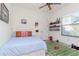 Well-lit bedroom with decor, a sports rug, light walls and wood-look flooring at 9250 Rhea Dr, Odessa, FL 33556