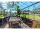 Greenhouse interior with a rustic table and chairs, surrounded by plants at 9250 Rhea Dr, Odessa, FL 33556