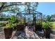 Charming greenhouse featuring an outdoor dining area and lush greenery at 9250 Rhea Dr, Odessa, FL 33556