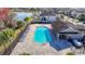 Aerial view of community pool featuring lounge chairs, clubhouse, and lush landscaping at 11846 Thicket Wood Dr, Riverview, FL 33579