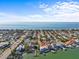 Aerial view of waterfront home with a neighborhood and Gulf of Mexico views at 1201 Bay Dr, Belleair Beach, FL 33786