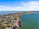 Aerial view of waterfront home along the coast at 1201 Bay Dr, Belleair Beach, FL 33786