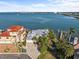 Waterfront home boasts lush tropical landscaping, a private dock, and stunning views of the bay and bridge at 1201 Bay Dr, Belleair Beach, FL 33786