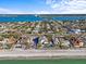 Aerial view of a beach neighborhood with bridge in the background at 1201 Bay Dr, Belleair Beach, FL 33786