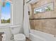 Bathroom showcasing tile walls and flooring and a shower and tub combination behind a shower curtain at 1201 Bay Dr, Belleair Beach, FL 33786