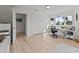 Bright bedroom with hardwood floors featuring a large closet, windows, and a workspace with a white desk and chair at 1201 Bay Dr, Belleair Beach, FL 33786
