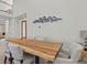 Dining room features a large wooden table and a decorative dolphin art piece on the wall at 1201 Bay Dr, Belleair Beach, FL 33786