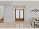 Elegant foyer featuring marble floors, decorative double doors, and staircase at 1201 Bay Dr, Belleair Beach, FL 33786