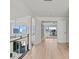 Bright hallway with hardwood floors leads to an office with waterfront views, enhancing the home's appeal at 1201 Bay Dr, Belleair Beach, FL 33786
