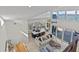 Open floor plan featuring a kitchen and living room with tall windows, providing a spacious and airy atmosphere at 1201 Bay Dr, Belleair Beach, FL 33786