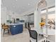 Bright kitchen with island, bar seating, stainless steel appliances, and adjacent breakfast nook at 1201 Bay Dr, Belleair Beach, FL 33786