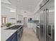 Bright kitchen featuring stainless steel appliances, a large island, and an open layout with easy access to the living area at 1201 Bay Dr, Belleair Beach, FL 33786