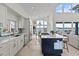 Spacious kitchen with island, modern appliances, breakfast nook with water view, and access to the living room at 1201 Bay Dr, Belleair Beach, FL 33786