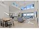 Bright and airy living room with high ceilings, large windows with bay views, and open floor plan at 1201 Bay Dr, Belleair Beach, FL 33786