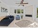 Bright living room boasts sleek tile flooring, fireplace and modern ceiling fan at 1201 Bay Dr, Belleair Beach, FL 33786