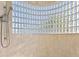 Unique shower with glass block window and handheld shower head, offering a spa-like experience at 1201 Bay Dr, Belleair Beach, FL 33786