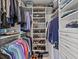 Well-organized walk-in closet with custom shelving provides ample storage for clothes and accessories at 1201 Bay Dr, Belleair Beach, FL 33786