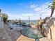 The backyard features a gorgeous pool, a rock waterfall, and stunning waterfront views at 1201 Bay Dr, Belleair Beach, FL 33786