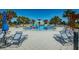 Community pool featuring lounge chairs, shade umbrellas, water features, and a nearby clubhouse at 13573 Circa Crossing Dr, Lithia, FL 33547