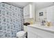 A bathroom featuring a white vanity, a patterned shower curtain, and a toilet at 14130 Rosemary Ln # 3203, Largo, FL 33774