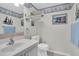Well-maintained bathroom with vanity, toilet, and nautical-themed decor at 14130 Rosemary Ln # 3203, Largo, FL 33774
