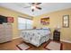 Bright bedroom with a ceiling fan and decorated with a beach motif at 14130 Rosemary Ln # 3203, Largo, FL 33774