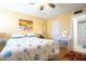 Bright bedroom with a tropical painting, ceiling fan and decorated with a beach motif at 14130 Rosemary Ln # 3203, Largo, FL 33774
