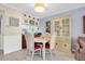 Eat-in dining area featuring white chairs, a matching cabinet, and adjoins the kitchen at 14130 Rosemary Ln # 3203, Largo, FL 33774
