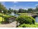 Beautiful view of the community pond featuring a fountain, bridge, and lush landscaping at 14130 Rosemary Ln # 3203, Largo, FL 33774