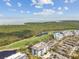 Elevated view of waterfront condo complex with golf course and nature preserve in the background at 14820 Rue De Bayonne # 205, Clearwater, FL 33762