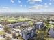 Scenic aerial view of a luxurious condo complex nestled among lush greenery and a meticulously maintained golf course at 14820 Rue De Bayonne # 205, Clearwater, FL 33762