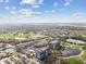 Overhead view of condo community with landscaping, golf course and lakes under blue skies with puffy white clouds at 14820 Rue De Bayonne # 205, Clearwater, FL 33762