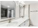 Bathroom with dual sinks, vanity with framed mirrors, and shower/tub combination at 14820 Rue De Bayonne # 205, Clearwater, FL 33762