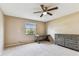 Neutral bedroom featuring a ceiling fan, desk near a window, and a dresser against the wall at 14820 Rue De Bayonne # 205, Clearwater, FL 33762