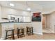 Cozy breakfast bar with barstools and kitchen view, perfect for casual dining and entertaining at 14820 Rue De Bayonne # 205, Clearwater, FL 33762