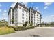 Wide angle showing the attractive building exterior, beautiful landscaping, and private entryway at 14820 Rue De Bayonne # 205, Clearwater, FL 33762