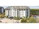 Exterior view showcasing condo building with covered parking, landscaping and well maintained grounds at 14820 Rue De Bayonne # 205, Clearwater, FL 33762