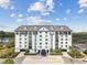 Beautiful condo community with architecture, manicured landscaping, and elegant porte cochere at 14820 Rue De Bayonne # 205, Clearwater, FL 33762
