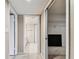 Hallway view leading to bathroom and walk-in closet with wire shelving for storage at 14820 Rue De Bayonne # 205, Clearwater, FL 33762