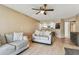 Open-concept living room showcasing couches, breakfast bar, a view into the kitchen, and light-colored wood flooring at 14820 Rue De Bayonne # 205, Clearwater, FL 33762
