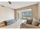 Comfortable living area with a couch, table and access to a balcony with an outdoor view at 14820 Rue De Bayonne # 205, Clearwater, FL 33762